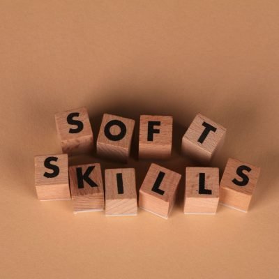 Wooden letter blocks spell out 'Soft Skills', highlighting business and personal development concepts.